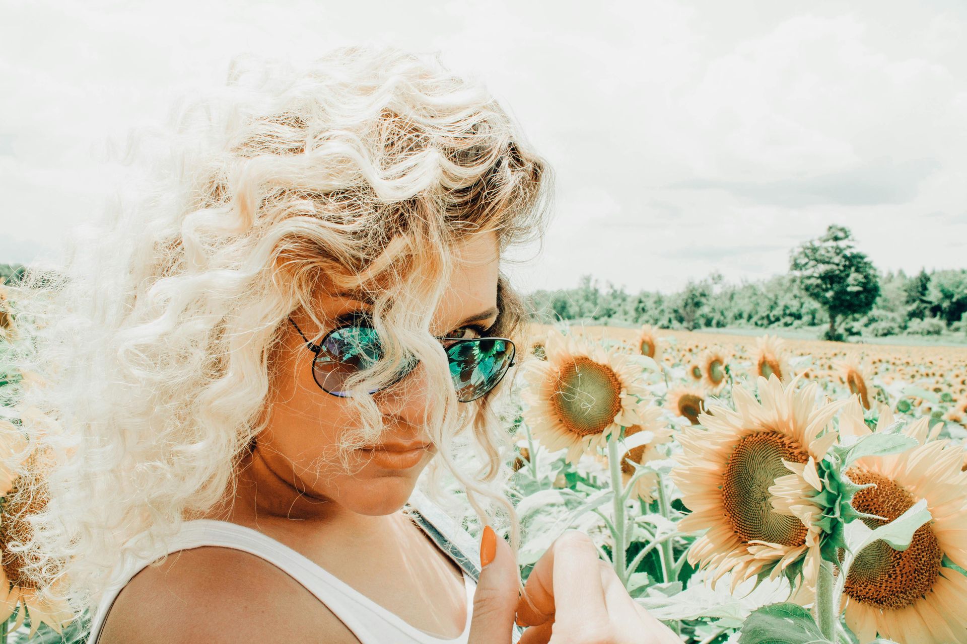 A blonde woman admiring sunflowers in a bright, open field, symbolizing a deep connection with nature and well-being. Reflects Scentriq’s commitment to creating uplifting environments through sustainable aromatherapy and personalized customer experiences. A blonde woman admiring sunflowers in a bright, open field, symbolizing a deep connection with nature and well-being. Reflects Scentriq’s commitment to creating uplifting environments through sustainable aromatherapy and personalized customer experiences.